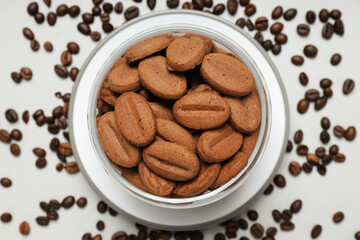 Concept of tasty snack for hot drink - cookies in the shape of coffee seeds