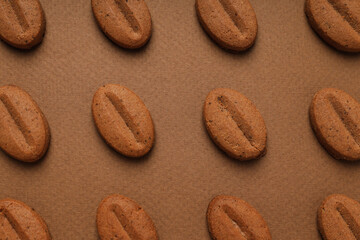 Concept of tasty snack for hot drink - cookies in the shape of coffee seeds