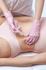 beautician makes lipolytic injections to burn fat on woman's belly and waist. Women's aesthetic...