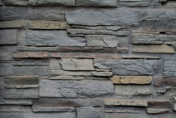 Cladding tiles imitating stone on wall close