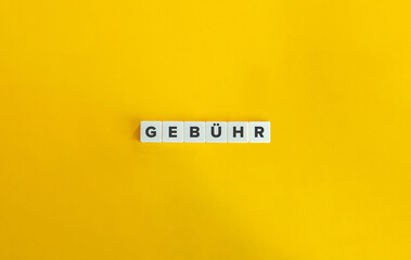 Gebühr (Fee in German). Block Letter Tiles on Yellow Background. Minimal Aesthetics.