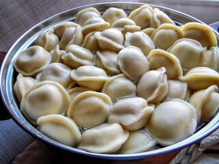 freshly boiled dumplings in a pot of boiling water