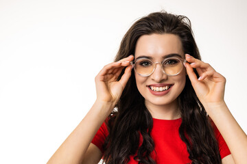 Smiling brunette woman in eyeglasses over white background