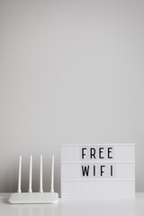 White router and lightbox with free wifi text