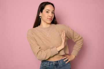 Young woman isolated on pink background making stop gesture