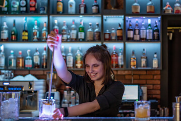 young woman bartender Making Cocktail in bar