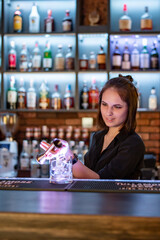 young woman bartender Making Cocktail in bar