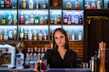 young woman bartender Making Cocktail in bar