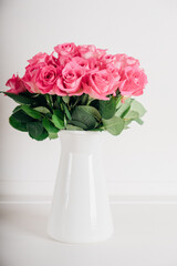 Beautiful bunch of fresh pink roses in full bloom against white background. Bouquet of flowers. Valentine's day or Mother's day card.