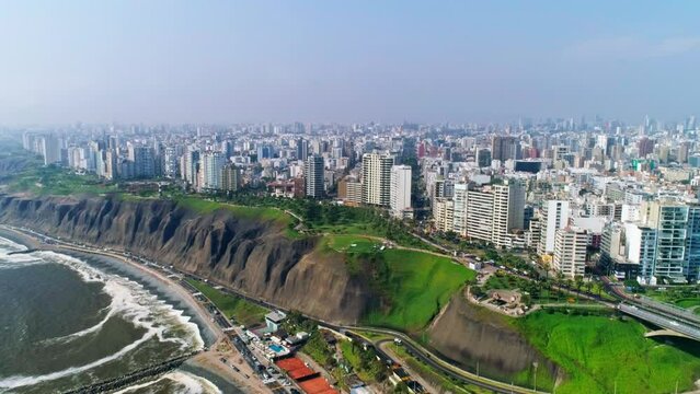Heavy traffic and paraglider on the windy coast of big city lima in Peru