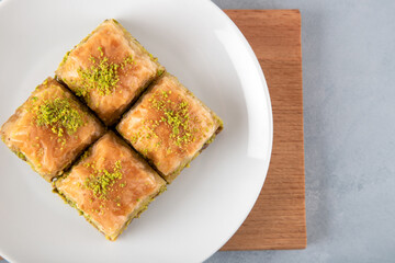 Pistachio Turkish baklava on a white plate,top view 