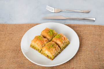 Pistachio Turkish baklava on a white plate,top view
