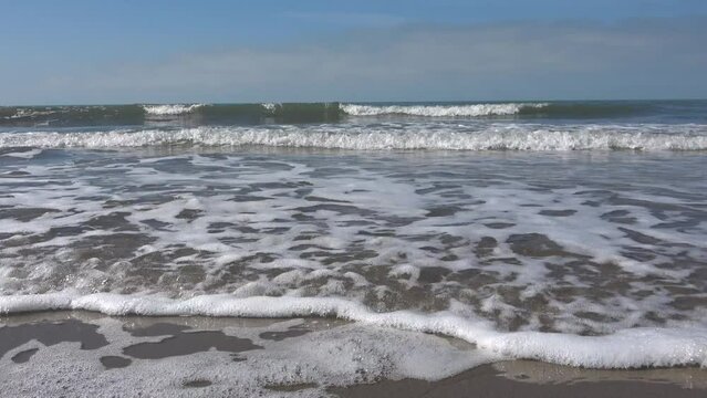 Mediterranean sea in spring. Small waves crash on the beach