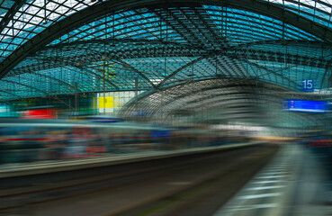 Abstract geometry of the metal and glass ceilings, poles, and railway tracks in Berlin Train Station in Germany