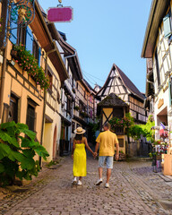 A couple of men and women on vacation in Eguisheim France Beautiful view of the colorful romantic...