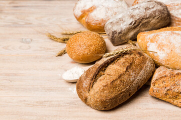 Homemade natural breads. Different kinds of fresh bread as background, perspective view with copy space
