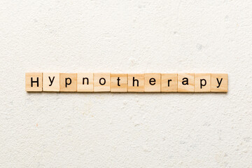 Hypnotherapy word written on wood block. Hypnotherapy text on cement table for your desing, concept