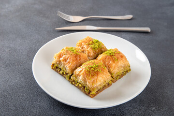 Pistachio Turkish baklava on a white plate.Traditional delicious Turkish baklava

