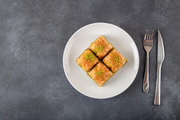 Pistachio Turkish baklava on a white plate.Traditional delicious Turkish baklava 