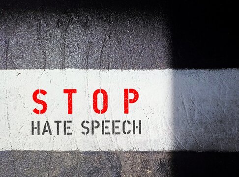 Black and white walkway with text STOP HATE SPEECH , concept of banning hate speech, no more spread hate on social media platform on internet or real life