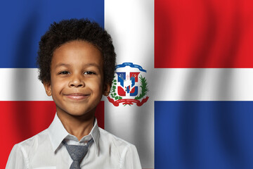 Dominican kid boy on flag of Dominican Republic background. Education and childhood concept - obrazy, fototapety, plakaty