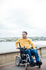 a special person with disabilities by the sea on a walk