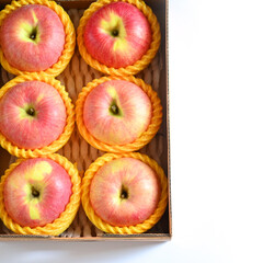 beautiful pink apple in the box on white background