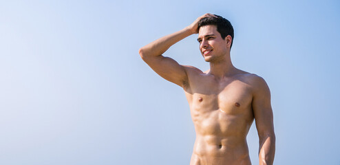 Portrait of handsome sexy caucasian man on the beach. Young healthy skin sun tan male with slim fit...