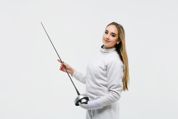 Teen girl in fencing costume with sword in hand on white background