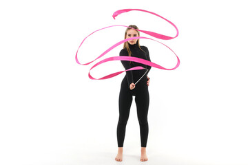 Girl in a black tight-fitting jumpsuit with a pink ribbon on a white background