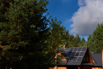 photovoltaic installation on the roofs of wooden houses in the forest