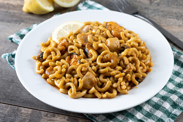 Traditional Spanish fideua. Noodle paella on wooden table