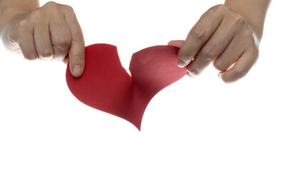 Hands tearing red paper heart on white background