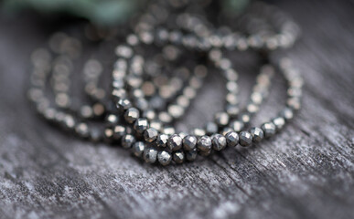 The photo with pyrite stones is made on the background of a wooden board and dried hydrangea.