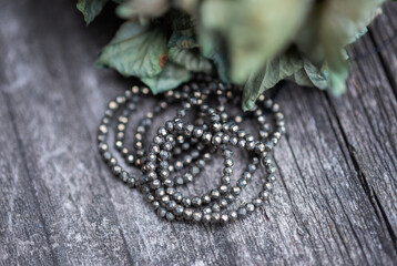 The photo with pyrite stones is made on the background of a wooden board and dried hydrangea.