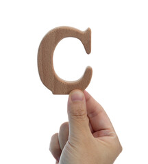 Hand holding wooden letter C