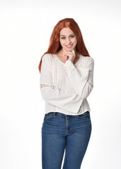  Close up portrait of beautiful woman model with long red hair, wearing casual outfit white blouse  top and denim jeans.  Posing with gestural arm poses, isolated on white studio background. 