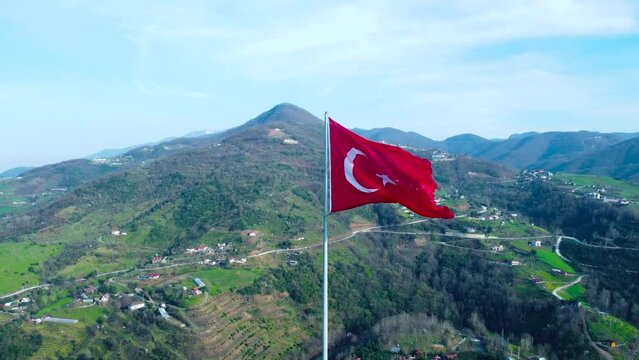 Turkish flag on top of the mountain. Turkish flag at the top with beautiful view. Turkish National holidays. 23 Nisan, 19 Mayis, 30 Agustos, 29 Ekim concept. Drone view. Aerial cinematic shot.
