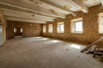 Old grunge interior with a destroyed brick wall