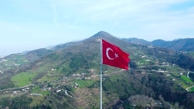 Turkish flag on top of the mountain. Turkish flag at the top with beautiful view. Turkish National holidays. 23 Nisan, 19 Mayis, 30 Agustos, 29 Ekim concept. Drone view. Aerial cinematic shot.