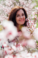 portrait of a woman in pink flowers peach garden trees nature parks walk