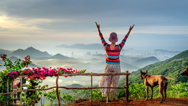 An Elderly Woman Practices Yoga Movements In The Morning In The Mountains Of Nha Trang. Looking Out Into The Distance Is The Coastal City Of Nha Trang, Vietnam