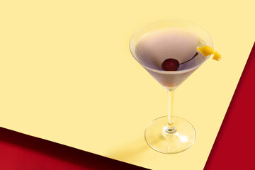 Classic aviation cocktail on red and yellow background. Copy space