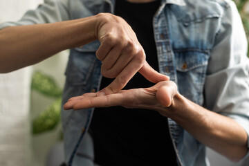 Man Using Sign Language To Communicate At Home