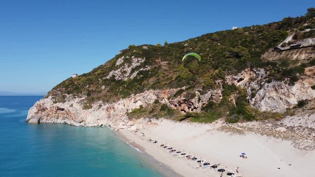 Aerial view of para glider flying over tropical sea in summer season on Milos beach on Lefkada island.