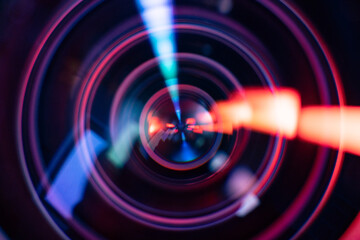 Colourful light reflecting in camera lens glass