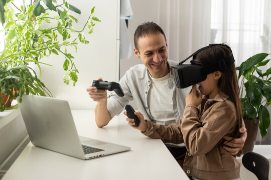 Little Girl Having Fun Time With Her Father Using VR Glasses At Home For Learning Molecular Structure. Homeschooling Concept.