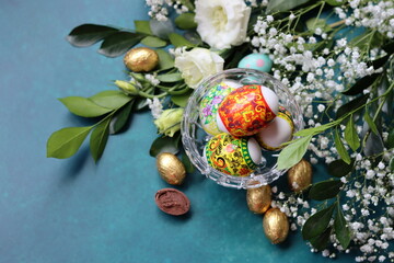 Easter greeting card. Colorful still life with eggs and flowers. 