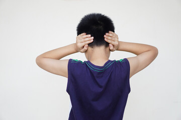 Back view of boy close his ears with two hands. Don't want to listen to anything. Concept, disobey,...