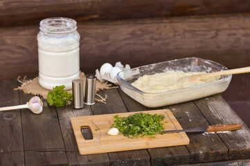 Bowl with dough for zucchini pancakes. Near flour, eggs and salt. The dough is ready. Step-by-step photo recipe for making dough for zucchini fritters